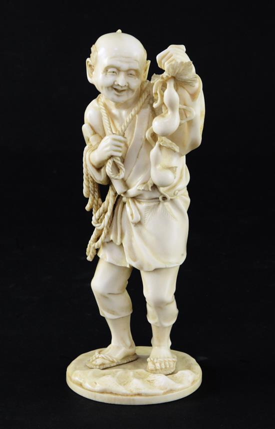 A Japanese ivory figure of a farmer, Meiji period, 16.5cm